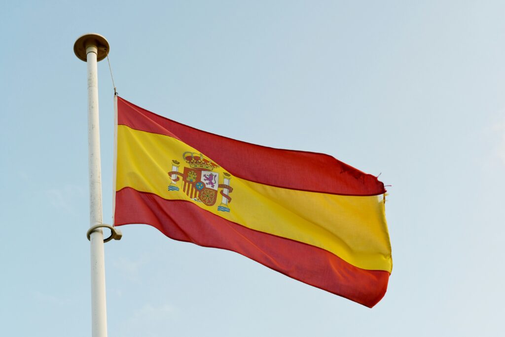 Spanish flag. Photo by Max Harlynking on Unsplash.